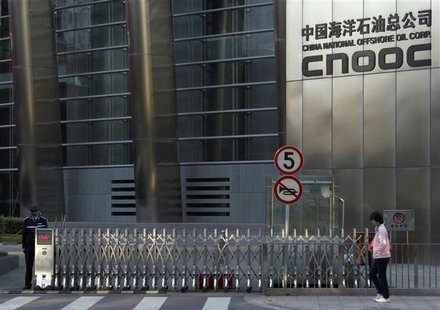 A woman walks past the entrance of the headquarters of China National Offshore Oil Corp (CNOOC) in Beijing in this September 23, 2010 file p A woman walks past the entrance of the headquarters of China National Offshore Oil Corp (CNOOC) in Beijing in this September 23, 2010 file p
