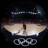 A worker sweeps the court before a training session at the Basketball Arena before the start of the London 2012 Olympic Games July 26, 2012. A worker sweeps the court before a training session at the Basketball Arena before the start of the London 2012 Olympic Games July 26, 2012.