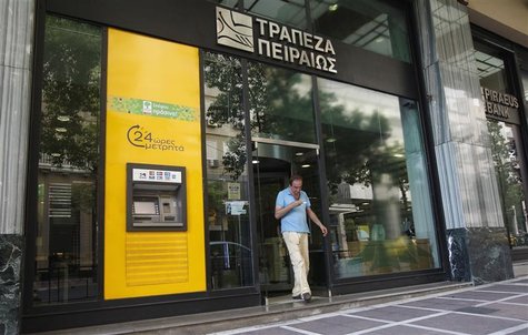 A man walks out of a Piraeus bank branch in central Athens July 16, 2012. REUTERS/John Kolesidis A man walks out of a Piraeus bank branch in central Athens July 16, 2012. REUTERS/John Kolesidis