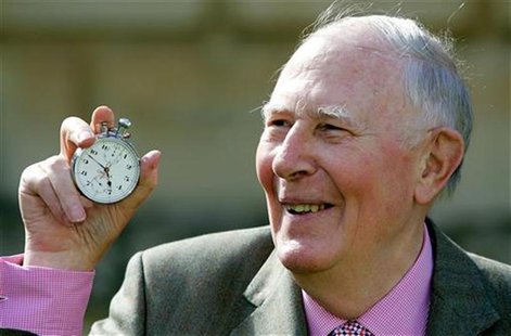 Sir Roger Bannister, who ran the first sub-four-minute mile in 1954, holds the stop watch used by [Harold Abrahams] to time the race during 