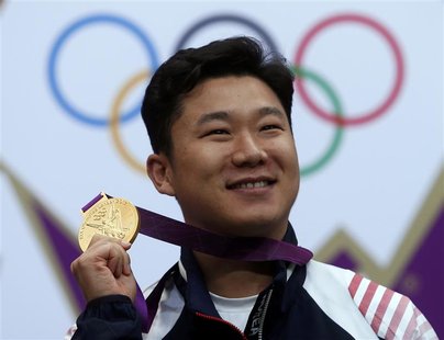 South Korea's Jin Jong-oh poses with his gold medal at the victory ceremony for the men's 10m air pistol event at the London 2012 Olympic Ga South Korea's Jin Jong-oh poses with his gold medal at the victory ceremony for the men's 10m air pistol event at the London 2012 Olympic Ga