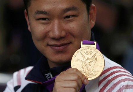 South Korea's Jin Jong-oh poses with his gold medal during the victory ceremony for the men's 10m air pistol event at the London 2012 Olympi South Korea's Jin Jong-oh poses with his gold medal during the victory ceremony for the men's 10m air pistol event at the London 2012 Olympi