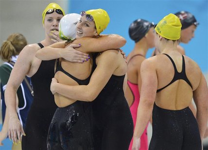 Australia's swimmers celebrate after they took first place in heat 2 during the women's 4x100m freestyle relay heats at the London 2012 Olym Australia's swimmers celebrate after they took first place in heat 2 during the women's 4x100m freestyle relay heats at the London 2012 Olym