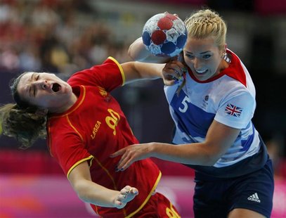 Montenegro's Milena Knezevic (L) fights for the ball with Britain's Nina Heglund during their women's handball Preliminaries Group A match a Montenegro's Milena Knezevic (L) fights for the ball with Britain's Nina Heglund during their women's handball Preliminaries Group A match a