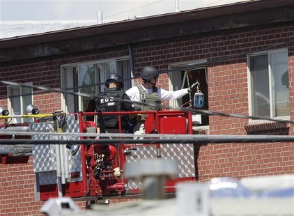 Law enforcement officers put a container filled with blue liquid to use in an explosion at the apartment where suspect James Eagan Holmes li Law enforcement officers put a container filled with blue liquid to use in an explosion at the apartment where suspect James Eagan Holmes li