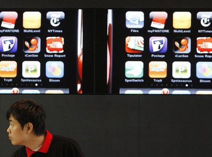 An employee at KT Corp works at the company's headquarters in Seoul July 30, 2010. REUTERS/Truth Leem An employee at KT Corp works at the company's headquarters in Seoul July 30, 2010. REUTERS/Truth Leem
