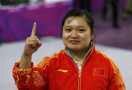 China's Guo Wenjun celebrates after winning the women's 10m Air Pistol qualification competition at the London 2012 Olympic Games in the Roy China's Guo Wenjun celebrates after winning the women's 10m Air Pistol qualification competition at the London 2012 Olympic Games in the Roy