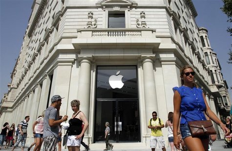 People walk past a closed shop, which will be opened and inaugurated as the largest Apple store in southern Europe on July 28, at Passeig de People walk past a closed shop, which will be opened and inaugurated as the largest Apple store in southern Europe on July 28, at Passeig de