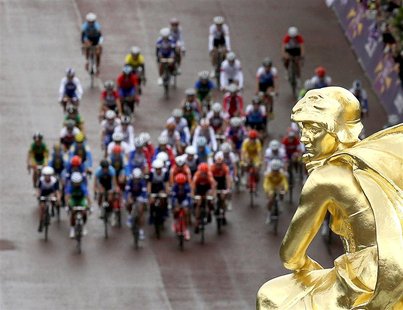 The peloton passes by the Queen Victoria memorial near Buckingham Palace during the women's cycling road race at the London 2012 Olympic Gam The peloton passes by the Queen Victoria memorial near Buckingham Palace during the women's cycling road race at the London 2012 Olympic Gam