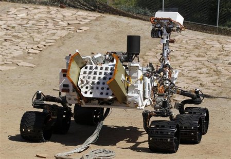 An engineering model of NASA's Curiosity Mars rover is seen from the rear in a sandy, Mars-like environment named the Mars Yard at NASA's Je An engineering model of NASA's Curiosity Mars rover is seen from the rear in a sandy, Mars-like environment named the Mars Yard at NASA's Je
