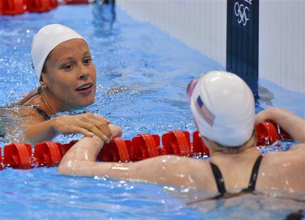 Italy's Federica Pellegrini (L) talks to Missy Franklin of the U.S. after finishing first in heat 3 of the women's 200m freestyle heats duri Italy's Federica Pellegrini (L) talks to Missy Franklin of the U.S. after finishing first in heat 3 of the women's 200m freestyle heats duri