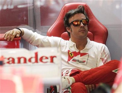 Ferrari Formula One driver Fernando Alonso of Spain waits in the pit during the third practice session for the Hungarian F1 Grand Prix at th Ferrari Formula One driver Fernando Alonso of Spain waits in the pit during the third practice session for the Hungarian F1 Grand Prix at th
