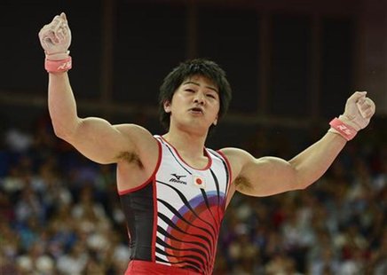 Koji Yamamuro of Japan gestures after competing in the rings during the men's gymnastics team final in the North Greenwich Arena during the Koji Yamamuro of Japan gestures after competing in the rings during the men's gymnastics team final in the North Greenwich Arena during the