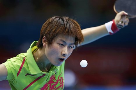 China's Ding Ning serves to Hong Kong's Jiang Huajun in their women's singles fourth round table tennis match at the ExCel venue during the China's Ding Ning serves to Hong Kong's Jiang Huajun in their women's singles fourth round table tennis match at the ExCel venue during the