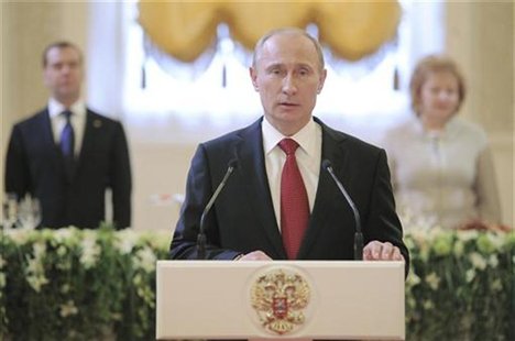 Russia's new President Vladimir Putin (front) speaks during a reception, dedicated to the start of his term as Russia's new President, with Russia's new President Vladimir Putin (front) speaks during a reception, dedicated to the start of his term as Russia's new President, with