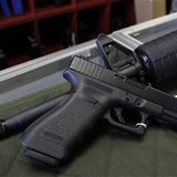 A Glock 22 pistol is seen laying on a Palmetto M4 assault rifle at the Rocky Mountain Guns and Ammo store in Parker, Colorado July 24, 2012. A Glock 22 pistol is seen laying on a Palmetto M4 assault rifle at the Rocky Mountain Guns and Ammo store in Parker, Colorado July 24, 2012.