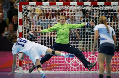 Russia's Natalia Shipilova scores a goal on Britain's goalkeeper Sarah Hargreaves in their women's handball Preliminaries Group A match at t Russia's Natalia Shipilova scores a goal on Britain's goalkeeper Sarah Hargreaves in their women's handball Preliminaries Group A match at t