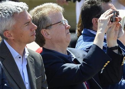 British Olympic Association (BOA) chairman Colin Moynihan (R) takes a photograph as British Olympian Jonathan Edwards looks on at a ceremony British Olympic Association (BOA) chairman Colin Moynihan (R) takes a photograph as British Olympian Jonathan Edwards looks on at a ceremony