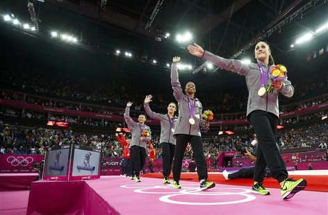 Team U.S.A gold medallists wave as they leave after the women's gymnastics team final in the North Greenwich Arena at the London 2012 Olympi Team U.S.A gold medallists wave as they leave after the women's gymnastics team final in the North Greenwich Arena at the London 2012 Olympi