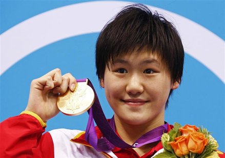 China's Ye Shiwen poses with her gold medal on the podium during the women's 400m individual medley victory ceremony at the London 2012 Olym China's Ye Shiwen poses with her gold medal on the podium during the women's 400m individual medley victory ceremony at the London 2012 Olym