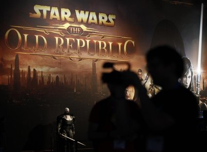 A visitor films in front of the 'Star Wars-Old Republic' exhibition stand during the Gamescom 2011 fair in Cologne August 17, 2011. REUTERS/ A visitor films in front of the 'Star Wars-Old Republic' exhibition stand during the Gamescom 2011 fair in Cologne August 17, 2011. REUTERS/