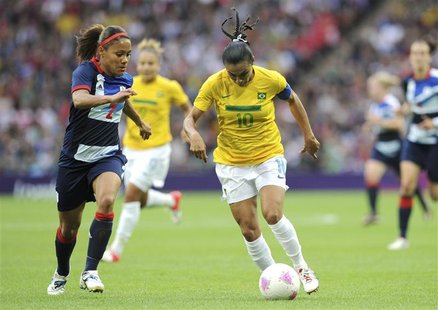 Brazil's Marta (R) dribbles the ball against Britain's Alex Scott during their women's Group E football match at the London 2012 Olympic Gam Brazil's Marta (R) dribbles the ball against Britain's Alex Scott during their women's Group E football match at the London 2012 Olympic Gam