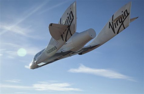 The Virgin Galactic SpaceShip2 (VSS Enterprise) glides toward Earth on its first test flight after being released from its WhiteKnight2 (VMS The Virgin Galactic SpaceShip2 (VSS Enterprise) glides toward Earth on its first test flight after being released from its WhiteKnight2 (VMS