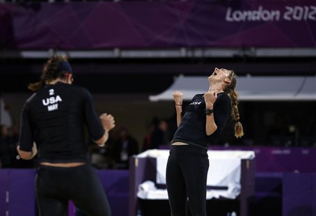 Misty May-Treanor (L) and Kerri Walsh Jennings of the U.S. celebrate after defeating Austria's Doris and Stefanie Schwaiger during their wom Misty May-Treanor (L) and Kerri Walsh Jennings of the U.S. celebrate after defeating Austria's Doris and Stefanie Schwaiger during their wom