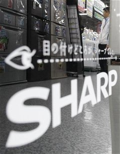 A man is reflected on Sharp's logo on its fridge at an electronic shop in Tokyo October 29, 2009. REUTERS/Kim Kyung-Hoon A man is reflected on Sharp's logo on its fridge at an electronic shop in Tokyo October 29, 2009. REUTERS/Kim Kyung-Hoon
