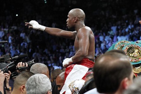 Floyd Mayweather Jr. of the U.S. celebrates his victory over WBA super welterweight champion Miguel Cotto of Puerto Rico following their tit Floyd Mayweather Jr. of the U.S. celebrates his victory over WBA super welterweight champion Miguel Cotto of Puerto Rico following their tit