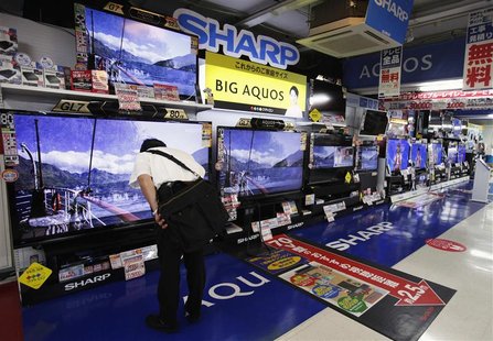 A man looks at Sharp Corp's Aquos TVs displayed at an electronics store in Tokyo August 2, 2012. REUTERS/Yuriko Nakao A man looks at Sharp Corp's Aquos TVs displayed at an electronics store in Tokyo August 2, 2012. REUTERS/Yuriko Nakao