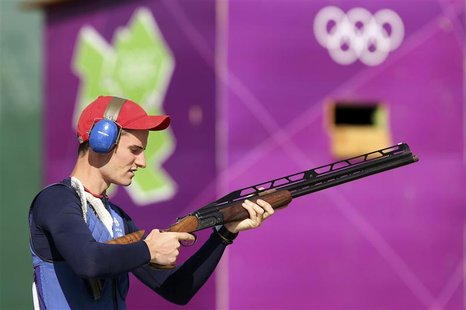 Britain's Peter Robert Russell Wilson checks his shotgun during the men's double trap shooting qualification round at the London 2012 Olympi Britain's Peter Robert Russell Wilson checks his shotgun during the men's double trap shooting qualification round at the London 2012 Olympi