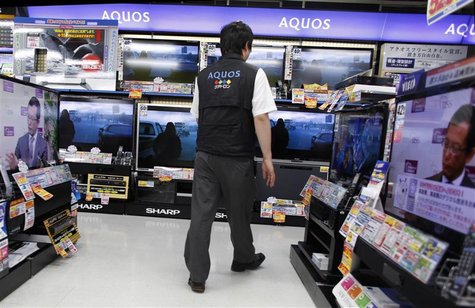 A salesperson walks among Sharp Corp's Aquos liquid-crystal display (LCD) televisions displayed at an electronic store in Tokyo in this June A salesperson walks among Sharp Corp's Aquos liquid-crystal display (LCD) televisions displayed at an electronic store in Tokyo in this June