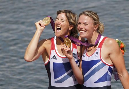 Gold medallists Britain's Katherine Grainger and Anna Watkins (L) celebrate with their medals during the awards ceremony for the women's dou Gold medallists Britain's Katherine Grainger and Anna Watkins (L) celebrate with their medals during the awards ceremony for the women's dou