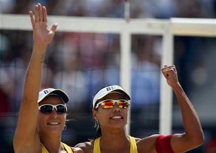 Brazil's Juliana Silva (R) and Larissa Franca celebrate after defeating the Netherlands' Madelein Meppelink and Sophie van Gestel during the Brazil's Juliana Silva (R) and Larissa Franca celebrate after defeating the Netherlands' Madelein Meppelink and Sophie van Gestel during the