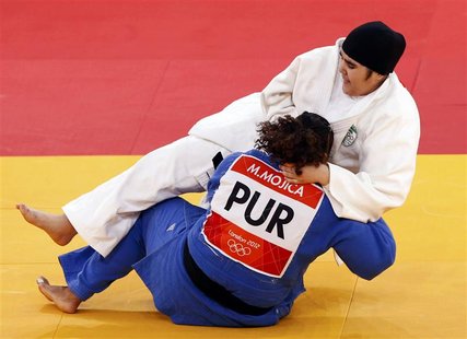 Saudi Arabia's Wojdan Shaherkani (top) fights with Puerto Rico's Melissa Mojica during their women's +78kg elimination round of 32 judo matc Saudi Arabia's Wojdan Shaherkani (top) fights with Puerto Rico's Melissa Mojica during their women's +78kg elimination round of 32 judo matc