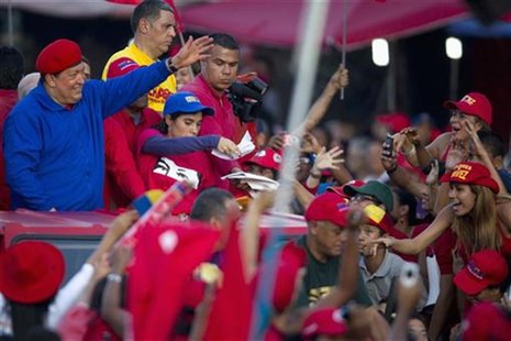 Venezuela's President Hugo Chavez (L) greets supporters during an election rally in the low income neighborhood of Petare in Caracas July 28 Venezuela's President Hugo Chavez (L) greets supporters during an election rally in the low income neighborhood of Petare in Caracas July 28