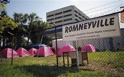 A cluster of pink tents, a makeshift shower and an unmanned security checkpoint are seen at a campsite known as "Romneyville", located behin A cluster of pink tents, a makeshift shower and an unmanned security checkpoint are seen at a campsite known as "Romneyville", located behin