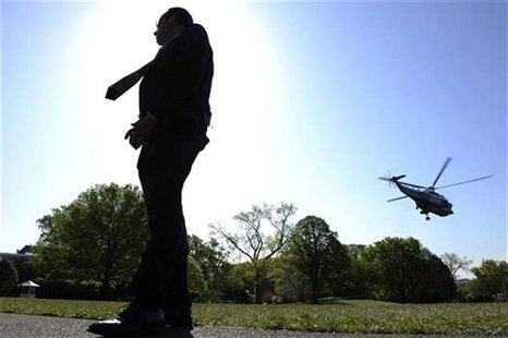 A Secret Service agent stands guard as U.S. President Barack Obama departs on the Marine One helicopter for travel to Colombia for the Summi A Secret Service agent stands guard as U.S. President Barack Obama departs on the Marine One helicopter for travel to Colombia for the Summi