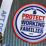 An American Federation of Teachers union member attending the AFT convention in Detroit, Michigan, wears a "Protect Working Families" sticke An American Federation of Teachers union member attending the AFT convention in Detroit, Michigan, wears a "Protect Working Families" sticke