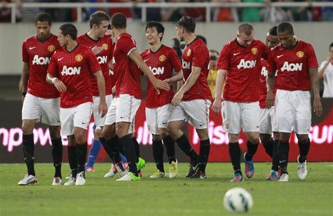 Manchester United's players celebrate after their teammate Shinji Kagawa (centre L) scored a goal during a friendly soccer match against Sha Manchester United's players celebrate after their teammate Shinji Kagawa (centre L) scored a goal during a friendly soccer match against Sha