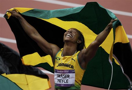 Jamaica's Shelly-Ann Fraser Pryce celebrates with her national flag after winning the women's 100m final at the London 2012 Olympic Games at Jamaica's Shelly-Ann Fraser Pryce celebrates with her national flag after winning the women's 100m final at the London 2012 Olympic Games at