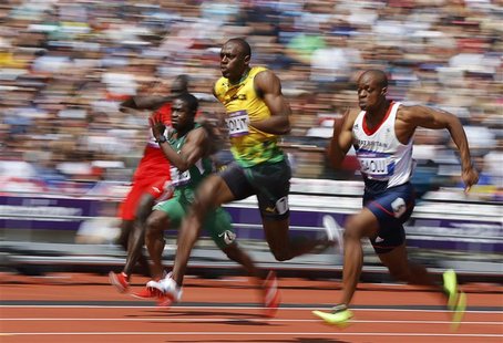 Usain Bolt (C) of Jamaica runs on his way to winning his 100m heat round 1 during the London 2012 Olympic Games at the Olympic Stadium Augus Usain Bolt (C) of Jamaica runs on his way to winning his 100m heat round 1 during the London 2012 Olympic Games at the Olympic Stadium Augus