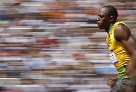 Usain Bolt of Jamaica runs on his way to winning his 100m heat round 1 during the London 2012 Olympic Games at the Olympic Stadium August 4, Usain Bolt of Jamaica runs on his way to winning his 100m heat round 1 during the London 2012 Olympic Games at the Olympic Stadium August 4,