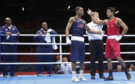 India's Krishan Vikas (R) is declared winner against Errol Spence of the U.S. in their Men's Welter (69kg) Round of 16 boxing match during t India's Krishan Vikas (R) is declared winner against Errol Spence of the U.S. in their Men's Welter (69kg) Round of 16 boxing match during t