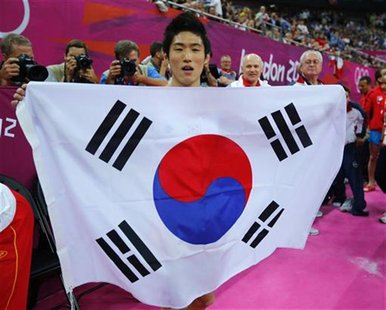 Yang Hak Seon of South Korea holds his flag as he celebrates winning a gold medal in the men's gymnastics vault final in the North Greenwich Yang Hak Seon of South Korea holds his flag as he celebrates winning a gold medal in the men's gymnastics vault final in the North Greenwich
