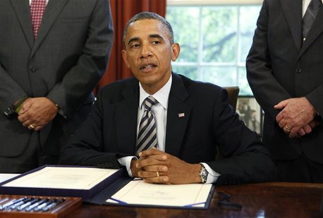 President Barack Obama answers a question about guns after he signs the Honoring America's Veterans and Caring for Camp Lejeune Families Act President Barack Obama answers a question about guns after he signs the Honoring America's Veterans and Caring for Camp Lejeune Families Act