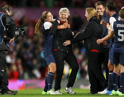 USA's Alex Morgan (L) celebrates with her coach Pia Sundhage after defeating Canada in the women's semi final soccer match at the London 201 USA's Alex Morgan (L) celebrates with her coach Pia Sundhage after defeating Canada in the women's semi final soccer match at the London 201