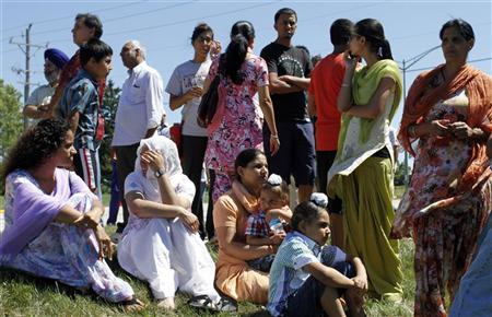 Members of the Sikh Temple wait for news following a mass shooting that left seven persons dead including the shooter in Oak Creek, Wisconsin August 5, 2012. REUTERS/Allen Fredrickson Members of the Sikh Temple wait for news following a mass shooting that left seven persons dead including the shooter in Oak Creek, Wisconsin August 5, 2012. REUTERS/Allen Fredrickson