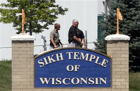 Officials gather near the Sikh Temple in Oak Creek, Wisconsin after a gunman killed six people on Sunday. Officials gather near the Sikh Temple in Oak Creek, Wisconsin after a gunman killed six people on Sunday.